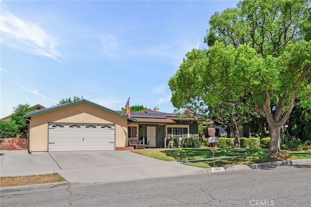 7420 London Ave, Rancho Cucamonga, CA 91730 - single story home with stucco siding, a garage, roof mounted solar panels, and concrete driveway