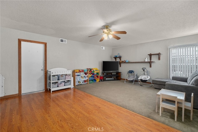 7420 London Ave, Rancho Cucamonga, CA 91730 - living area with a ceiling fan, a textured ceiling, and wood finished floors
