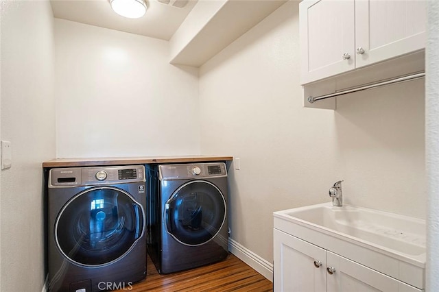 11905 Flicker Cv, Corona, CA 92883 - laundry area with independent washer and dryer, cabinet space, and wood finished floors