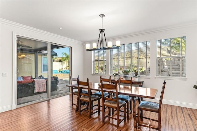11905 Flicker Cv, Corona, CA 92883 - dining area with wood finished floors, crown molding, and a chandelier