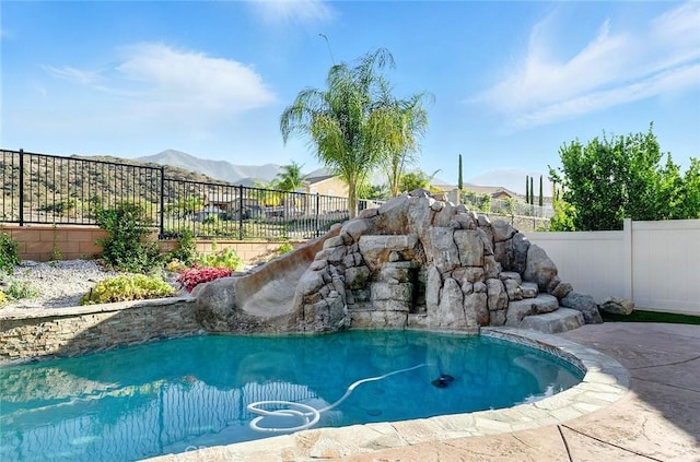 11905 Flicker Cv, Corona, CA 92883 - view of pool with a fenced backyard, a mountain view, and a water slide