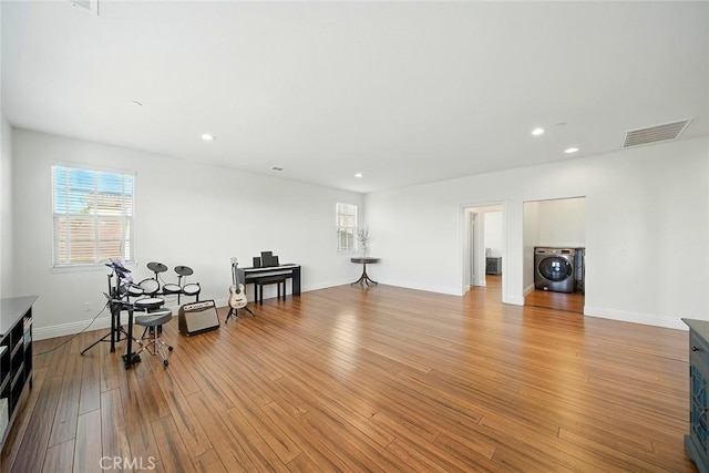 11905 Flicker Cv, Corona, CA 92883 - sitting room with washer / dryer, light wood-style floors, and recessed lighting