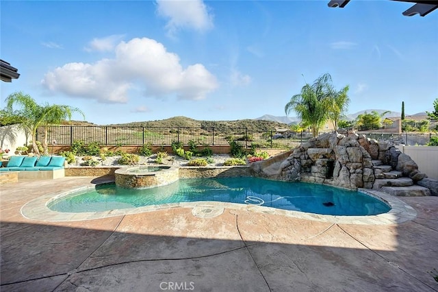 11905 Flicker Cv, Corona, CA 92883 - view of pool featuring a fenced backyard, a mountain view, a pool with connected hot tub, and a patio area