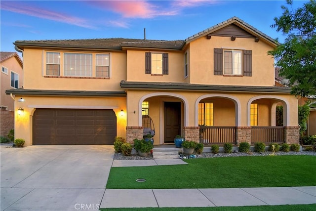 11905 Flicker Cv, Corona, CA 92883 - view of front of home with a porch, concrete driveway, a front lawn, an attached garage, and stucco siding