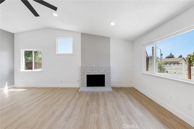 22959 Vought St, Moreno Valley, CA 92553 - unfurnished living room featuring ceiling fan, light wood finished floors, a fireplace, lofted ceiling, and recessed lighting