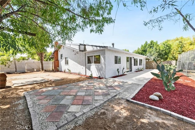 22959 Vought St, Moreno Valley, CA 92553 - back of property featuring a fenced backyard, a patio area, and stucco siding