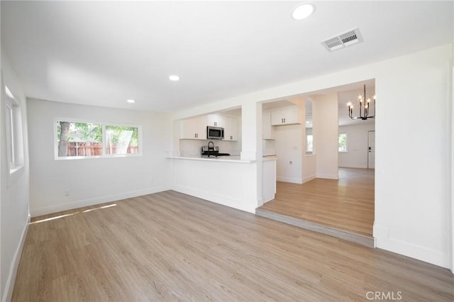 22959 Vought St, Moreno Valley, CA 92553 - unfurnished living room featuring a chandelier, light wood-style flooring, and recessed lighting