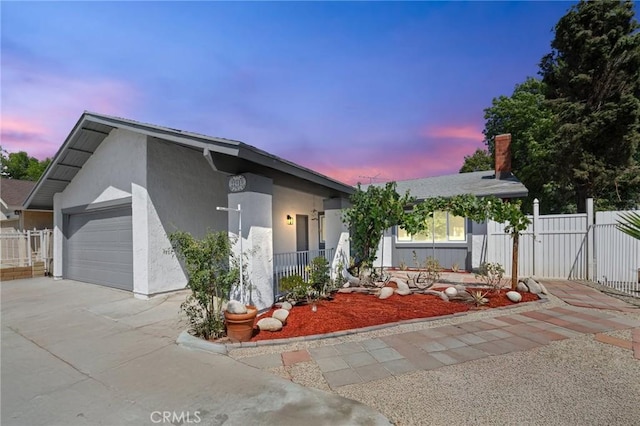 22959 Vought St, Moreno Valley, CA 92553 - view of front of house featuring an attached garage, driveway, a gate, and stucco siding
