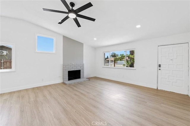 22959 Vought St, Moreno Valley, CA 92553 - unfurnished living room with vaulted ceiling, healthy amount of natural light, ceiling fan, a fireplace, and light wood finished floors