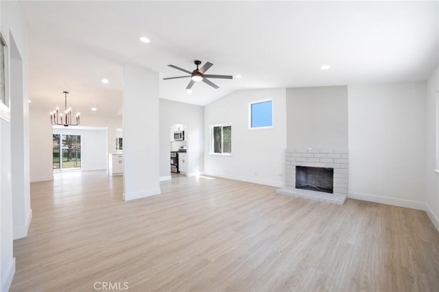 22959 Vought St, Moreno Valley, CA 92553 - unfurnished living room with a brick fireplace, healthy amount of natural light, vaulted ceiling, light wood-style floors, and a chandelier