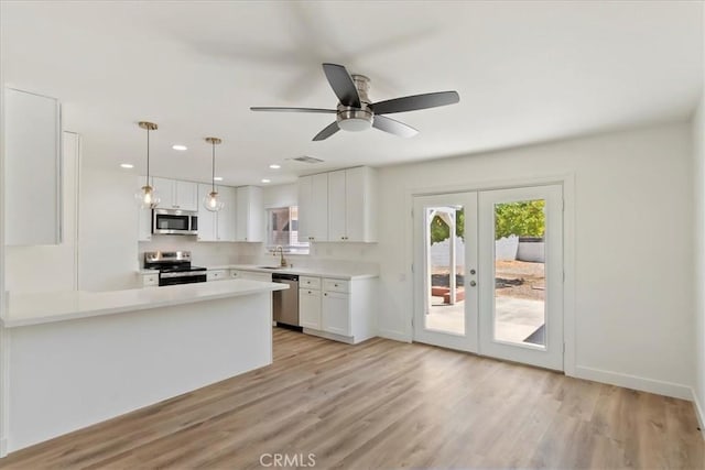 43000 Connecticut St, Palm Desert, CA 92211 - kitchen with stainless steel appliances, french doors, white cabinetry, healthy amount of natural light, and recessed lighting