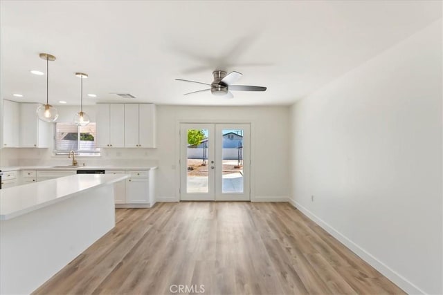 43000 Connecticut St, Palm Desert, CA 92211 - kitchen with french doors, light countertops, plenty of natural light, white cabinetry, and recessed lighting