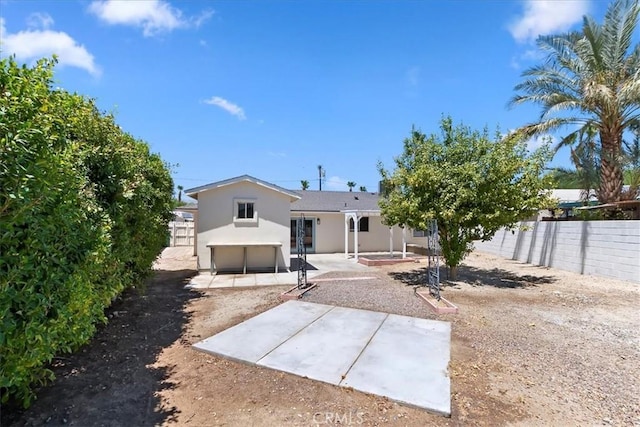 43000 Connecticut St, Palm Desert, CA 92211 - rear view of property featuring a patio, a fenced backyard, stucco siding, and a garage
