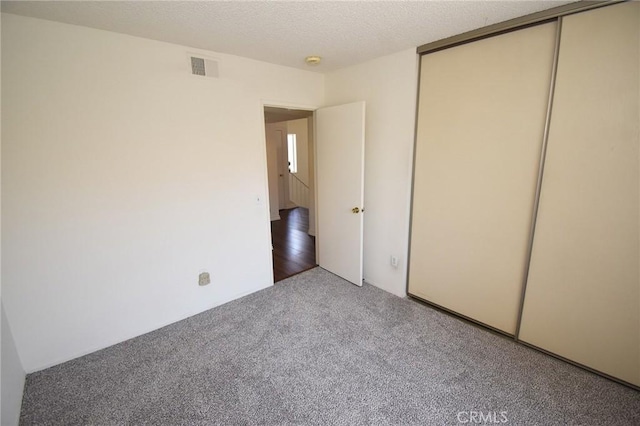 10246 Chaparral Way Unit G, Rancho Cucamonga, CA 91730 - unfurnished bedroom with carpet floors, a closet, and a textured ceiling