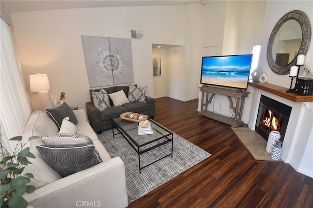 10246 Chaparral Way Unit G, Rancho Cucamonga, CA 91730 - living room featuring wood finished floors, a fireplace with flush hearth, and high vaulted ceiling