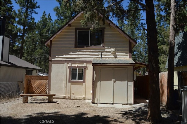 2062 9th Ln, Big Bear City, CA 92314 - rear view of house featuring a storage unit and stucco siding
