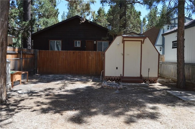 2062 9th Ln, Big Bear City, CA 92314 - view of side of home featuring a storage shed and a fenced backyard