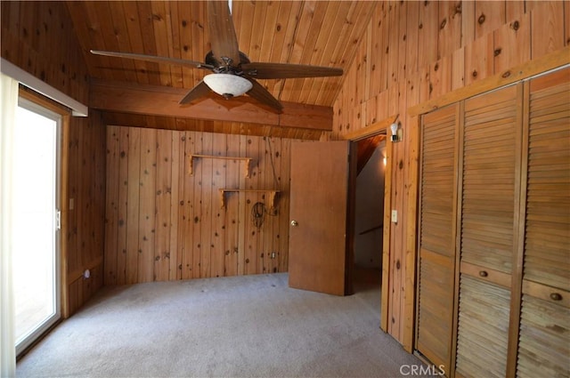 2062 9th Ln, Big Bear City, CA 92314 - unfurnished bedroom with wood walls, carpet floors, multiple windows, wood ceiling, and a closet