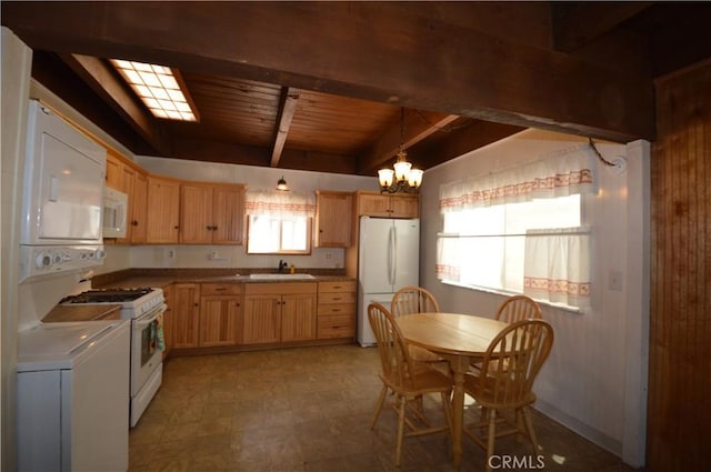 2062 9th Ln, Big Bear City, CA 92314 - kitchen featuring white appliances, light brown cabinetry, a chandelier, a wood ceiling with exposed beams, and wooden walls