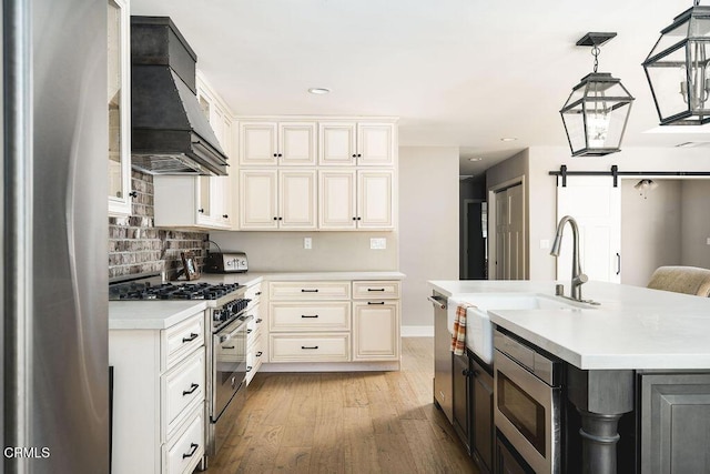 3041 Fairlea Rd, Santa Ynez, CA 93460 - kitchen featuring appliances with stainless steel finishes, custom exhaust hood, light countertops, light wood finished floors, and tasteful backsplash