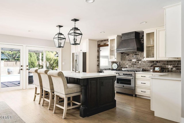 3041 Fairlea Rd, Santa Ynez, CA 93460 - kitchen with custom range hood, stainless steel appliances, light countertops, backsplash, and recessed lighting