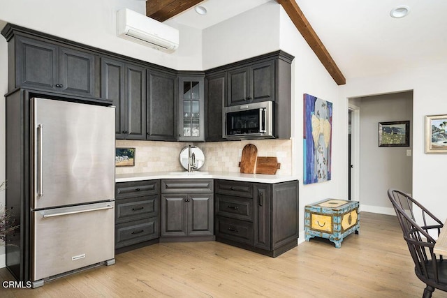3041 Fairlea Rd, Santa Ynez, CA 93460 - kitchen with appliances with stainless steel finishes, a wall mounted air conditioner, backsplash, light countertops, and glass insert cabinets