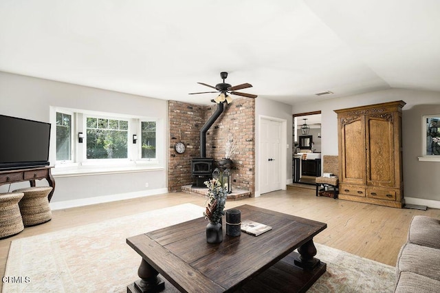 3041 Fairlea Rd, Santa Ynez, CA 93460 - living area featuring a wood stove, light wood-style flooring, a ceiling fan, and vaulted ceiling
