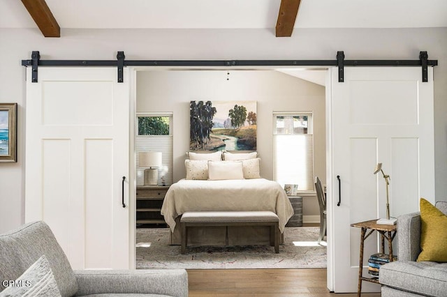 3041 Fairlea Rd, Santa Ynez, CA 93460 - bedroom with a barn door, beam ceiling, and wood finished floors