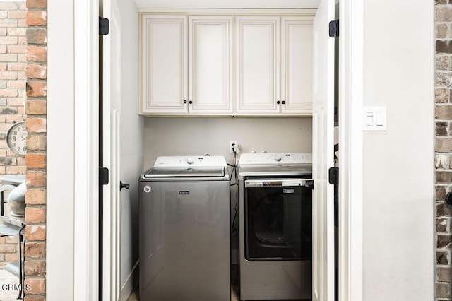 3041 Fairlea Rd, Santa Ynez, CA 93460 - laundry room featuring washer and clothes dryer, cabinet space, and brick wall