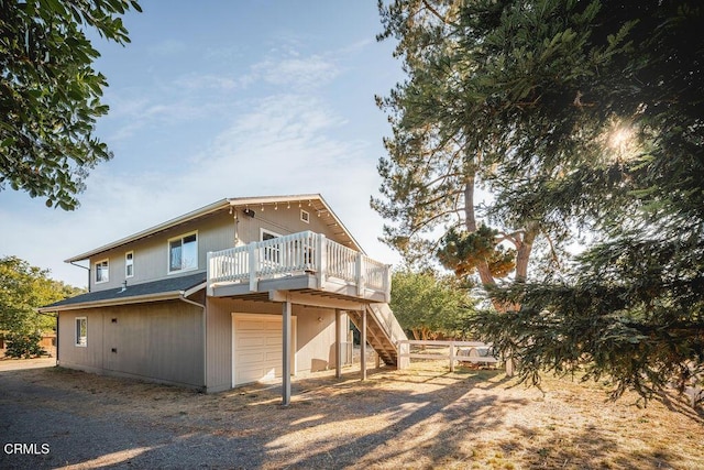 3041 Fairlea Rd, Santa Ynez, CA 93460 - rear view of house featuring an attached garage, stairs, and a deck