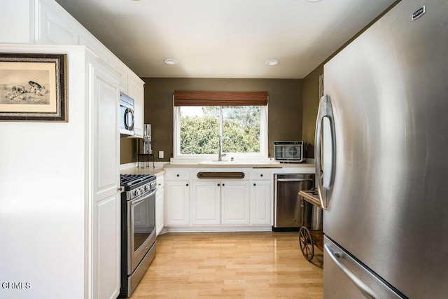3041 Fairlea Rd, Santa Ynez, CA 93460 - kitchen with appliances with stainless steel finishes, white cabinetry, light wood-style flooring, light countertops, and recessed lighting