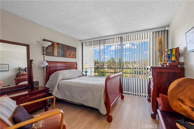 24055 W Paseo Del Lago Unit 753, Laguna Woods, CA 92637 - bedroom with wood finished floors and a textured ceiling
