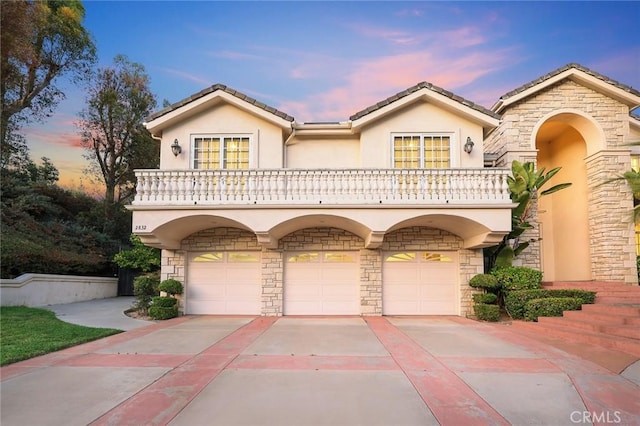 2832 Oak Knoll Dr, Diamond Bar, CA 91765 - mediterranean / spanish home with stucco siding, an attached garage, driveway, stone siding, and a tiled roof