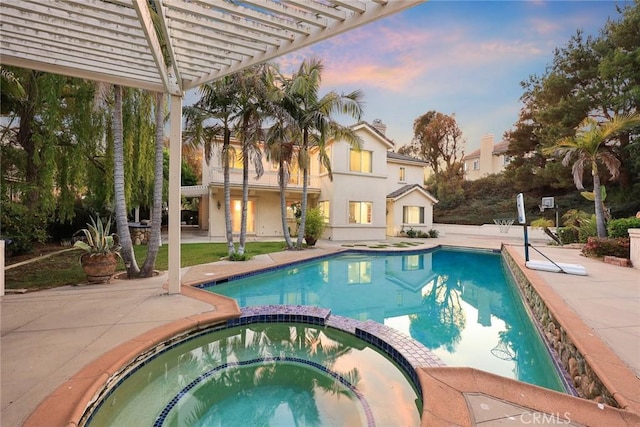2832 Oak Knoll Dr, Diamond Bar, CA 91765 - pool at dusk featuring a pool with connected hot tub, a pergola, and a patio area