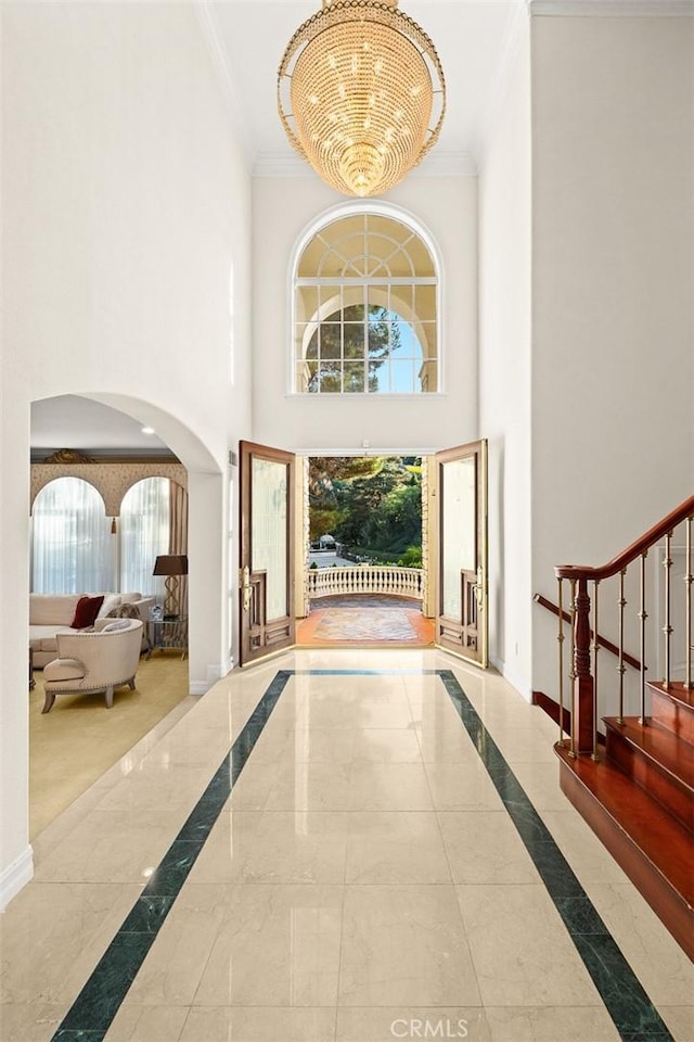 2832 Oak Knoll Dr, Diamond Bar, CA 91765 - foyer featuring crown molding, arched walkways, inlaid floor details, a high ceiling, and stairs