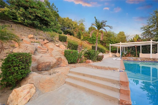 2832 Oak Knoll Dr, Diamond Bar, CA 91765 - pool at dusk with an outdoor pool, a patio area, and a pergola