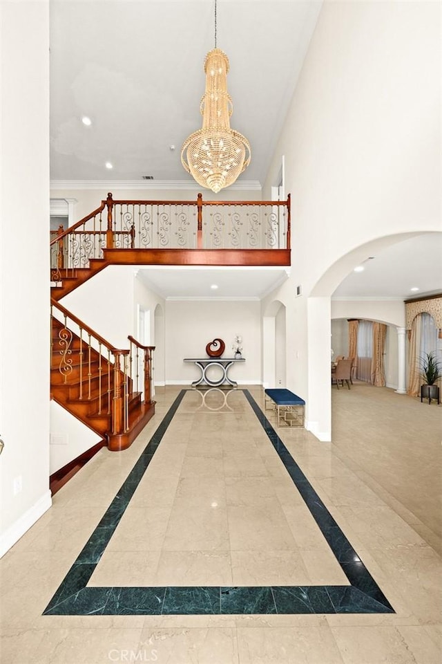 2832 Oak Knoll Dr, Diamond Bar, CA 91765 - foyer featuring inlaid floor details, arched walkways, a chandelier, stairs, and a towering ceiling
