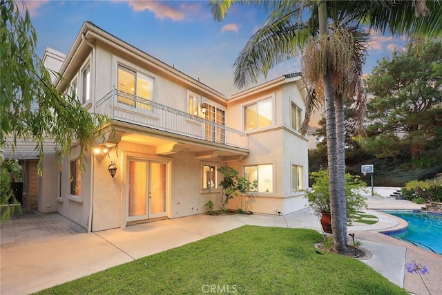 2832 Oak Knoll Dr, Diamond Bar, CA 91765 - view of front of house with a balcony, stucco siding, a patio, a front lawn, and an outdoor pool