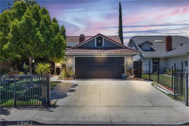 25211 Dana Ln, Moreno Valley, CA 92551 - view of front facade featuring an attached garage, stucco siding, driveway, and a tile roof