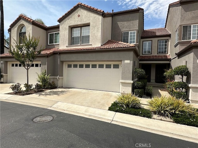 27721 Rubidoux, Mission Viejo, CA 92692 - mediterranean / spanish house with concrete driveway, stucco siding, a tiled roof, and an attached garage
