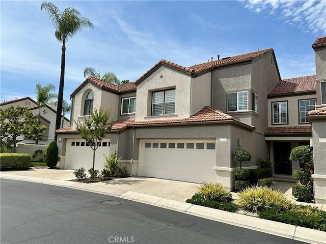 27721 Rubidoux, Mission Viejo, CA 92692 - mediterranean / spanish home with a tiled roof, concrete driveway, stucco siding, and an attached garage