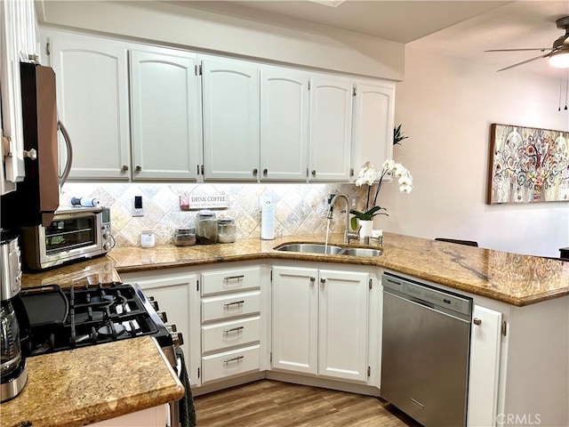 27721 Rubidoux, Mission Viejo, CA 92692 - kitchen with appliances with stainless steel finishes, a peninsula, a ceiling fan, and backsplash