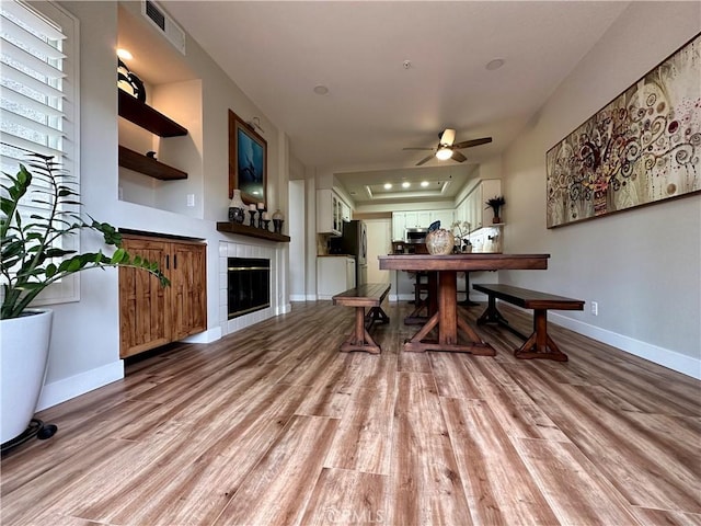 27721 Rubidoux, Mission Viejo, CA 92692 - dining area with light wood-style flooring, ceiling fan, and a tile fireplace