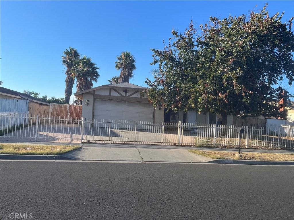 25304 Old Farm St, Moreno Valley, CA 92553 - obstructed view of property with stucco siding, concrete driveway, and an attached garage