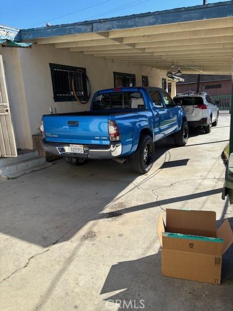 711 N Crane Ave, Compton, CA 90221 - view of vehicle parking featuring a carport and driveway