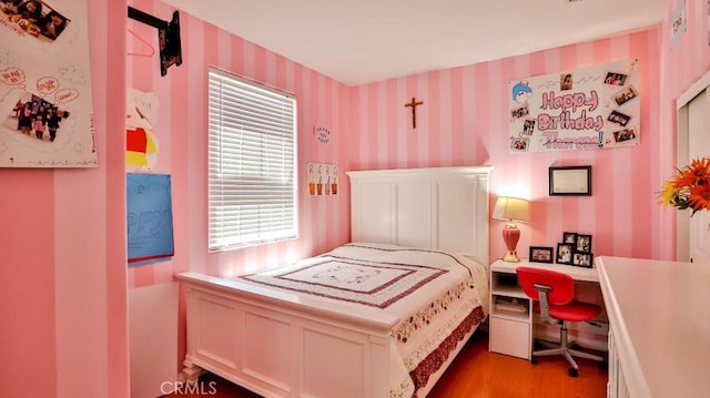 2056 Mission Hills Dr, Oxnard, CA 93036 - bedroom with wallpapered walls, wood finished floors, and an office area