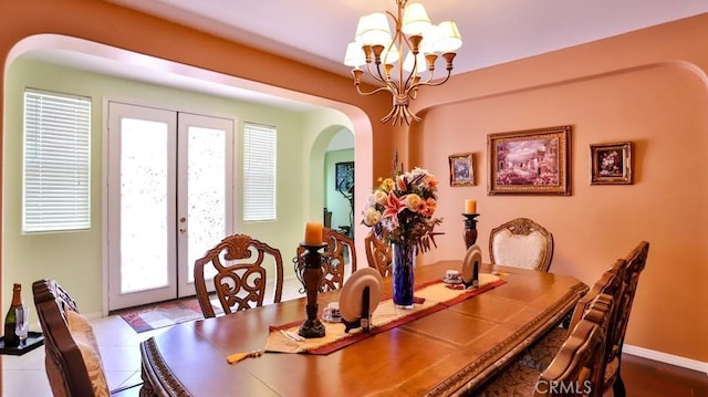 2056 Mission Hills Dr, Oxnard, CA 93036 - dining area featuring arched walkways, a chandelier, and french doors