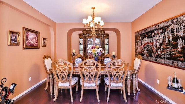 2056 Mission Hills Dr, Oxnard, CA 93036 - dining area with arched walkways, wood finished floors, and a chandelier