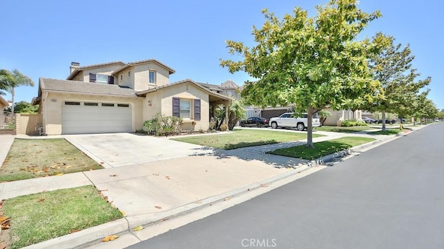2056 Mission Hills Dr, Oxnard, CA 93036 - view of front of house with concrete driveway, stucco siding, an attached garage, a tile roof, and a front yard