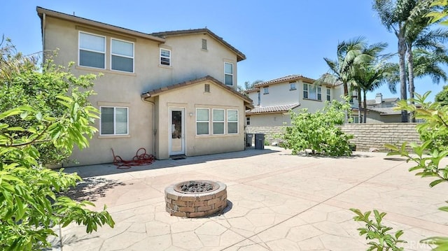 2056 Mission Hills Dr, Oxnard, CA 93036 - rear view of property featuring a fire pit, stucco siding, and a patio